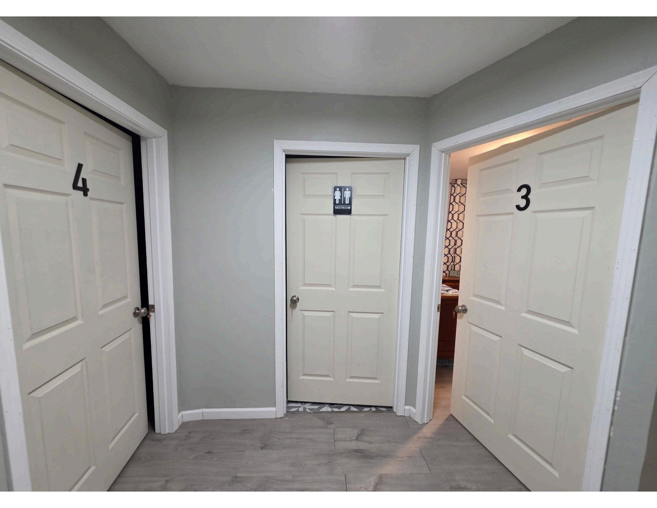 Resident hallway with numbered private rooms